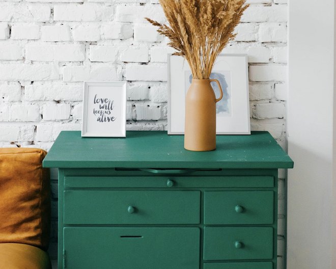 Desk with decorations next to a couch
